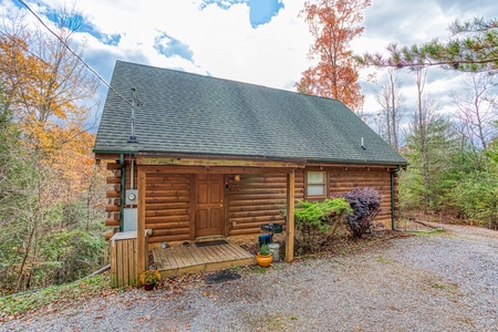 Looking at the cabin from the gravel parking at Enchanted Evening, a 1-bedroom cabin rental located in Pigeon Forge