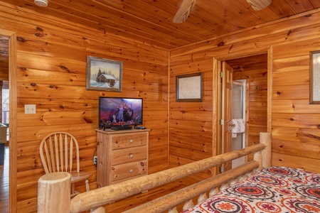 Dresser, TV, and chair at Hickernut Lodge, a 5-bedroom cabin rental located in Pigeon Forge