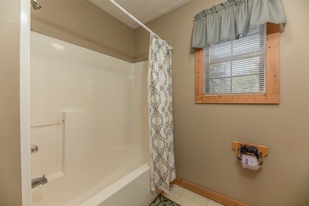 Bathroom with a tub and shower at Bearadise 4 Us, a 3 bedroom cabin rental located in Pigeon Forge