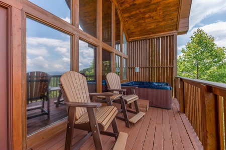 High Adirondack chairs on the deck at Away From it All, a 1 bedroom cabin rental located in Pigeon Forge