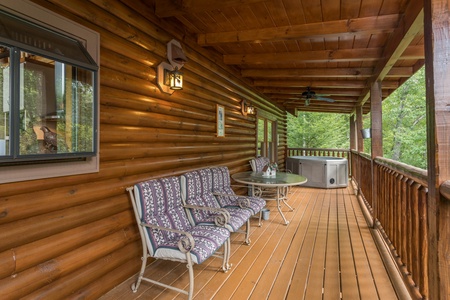Porch seating on a deck at Laid Back, a 2 bedroom cabin rental located in Pigeon Forge
