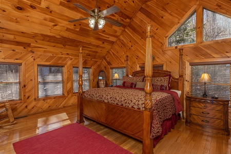 Four post bed with night stands and lamps in the loft at Hatcher Mountain Retreat a 2 bedroom cabin rental located in Pigeon Forge