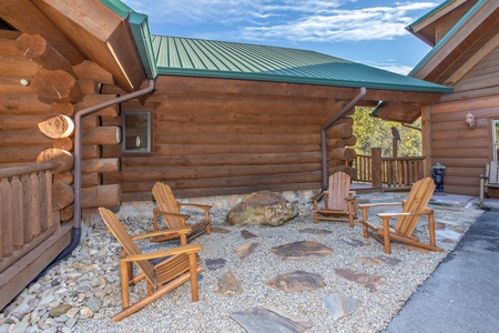 Four Adirondack chairs on a stone patio at Great View Lodge, a 5-bedroom cabin rental located in Pigeon Forge