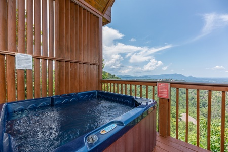 Hot tub and privacy fence on a deck at Away From it All, a 1 bedroom cabin rental located in Pigeon Forge