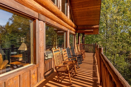 Rocking chairs on an open deck at Grizzly's Den, a 5 bedroom cabin rental located in Gatlinburg