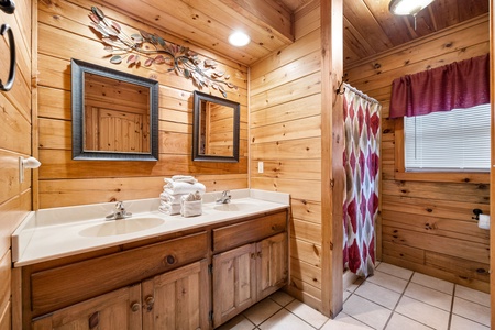 Bathroom with a double vanity and shower at Alpine Sondance, a 2 bedroom cabin rental located in Pigeon Forge
