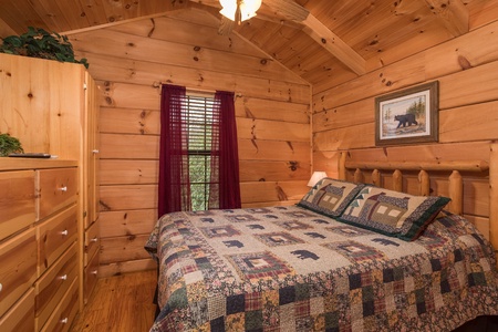 King-sized log bed at Boogie Bear, a 1-bedroom cabin rental located in Gatlinburg