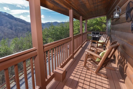 Covered deck With Adirondack Chairs at Mountain Mama, a 3 bedroom cabin rental located in pigeon forge