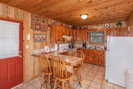 Kitchen with dining space for four at the counter at Apple View, a 2 bedroom cabin rental located in Pigeon Forge