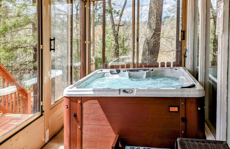 Hot tub on screened in porch at Buena Vista Getaway, 3 bedroom cabin rental located in Gatlinburg