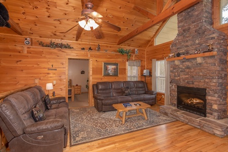Living room with two couches and a stone fireplace at Bearly in the Mountains, a 5-bedroom cabin rental located in Pigeon Forge