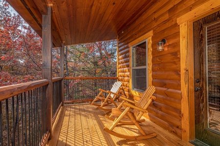 Rocking chairs on a covered deck at Pinot Splash, a 4 bedroom cabin rental located in Gatlinburg