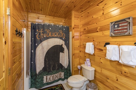 Bathroom with black bear decor at Bear Country, a 3-bedroom cabin rental located in Pigeon Forge