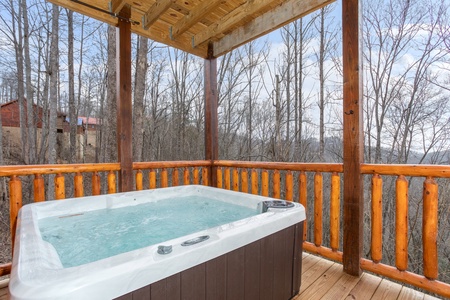 Hot tub on a covered deck at Happy Bear's Hideaway, a 2 bedroom cabin rental located in Gatlinburg