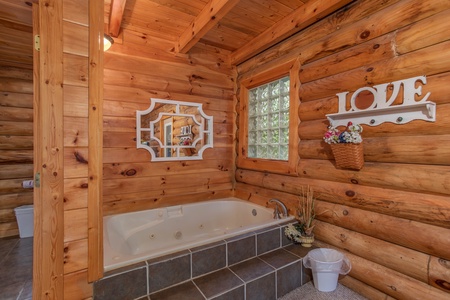 bathroom with jacuzzi tub at alpine something blue a 1 bedroom cabin rental located in pigeon forge