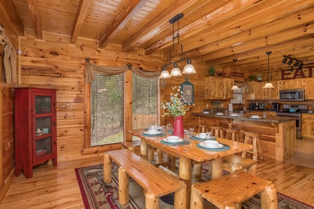 Dining table for six and kitchen with counter seating for four at Mountain View Meadows, a 3 bedroom cabin rental located in Pigeon Forge
