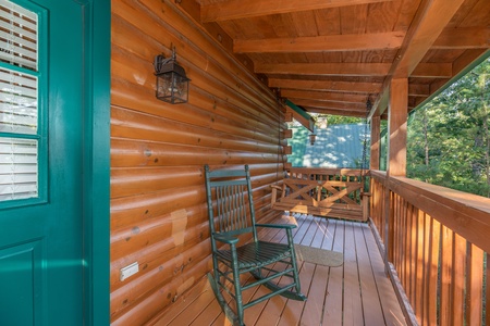Rocking chair and swing on a covered porch at Southern Charm, a 2 bedroom cabin rental located in Pigeon Forge