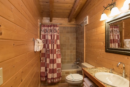 Bathroom with a tub and shower at Laid Back, a 2 bedroom cabin rental located in Pigeon Forge