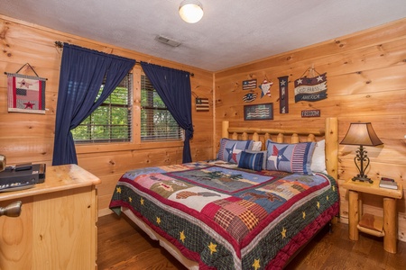 King log bed at Patriot Pointe, a 5 bedroom cabin rental located in Pigeon Forge