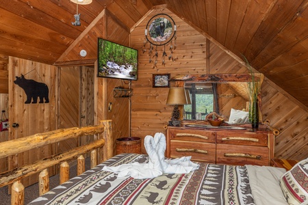 TV, dresser, and mirror in a bedroom at Bearing Views, a 3 bedroom cabin rental located in Pigeon Forge