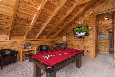 Pool table and television at Mountain View Meadows, a 3 bedroom cabin rental located in Pigeon Forge