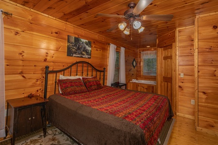 Bedroom with a king bed and jacuzzi at Firefly Ridge, a 2 bedroom cabin rental located in Pigeon Forge
