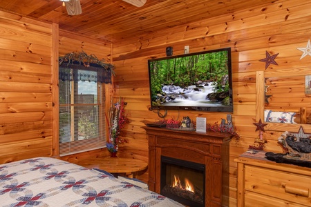 Fireplace and flat screen television in a bedroom at Bear Country, a 3-bedroom cabin rental located in Pigeon Forge