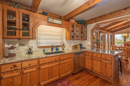 Kitchen with granite counters and breakfast bar at Lazy Bear Retreat, a 4 bedroom cabin rental located in Pigeon Forge