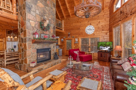 Living room with a stone fireplace at The Original American Dream, a 2 bedroom cabin rental located in Gatlinburg