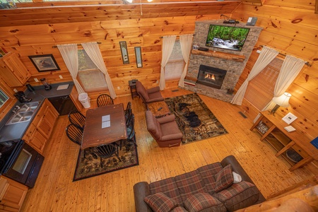Looking down at the dining and living spaces at Firefly Ridge, a 2 bedroom cabin rental located in Pigeon Forge
