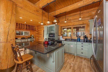 Kitchen island with granite top at Grizzly's Den, a 5 bedroom cabin rental located in Gatlinburg