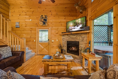 Stairs and fireplace with flat screen at Lazy Bear Lodge