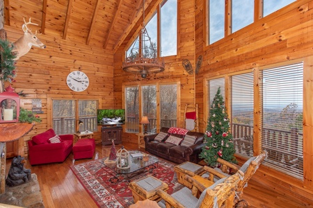 Living room with a Christmas tree at The Original American Dream, a 2 bedroom cabin rental located in Gatlinburg
