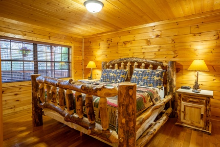 King-sized wood bed at 3 Crazy Cubs, a 5 bedroom cabin rental located in pigeon forge