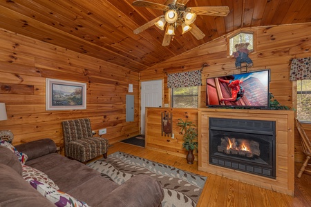 Fireplace and TV in a living room at A Cheerful Heart, a 2 bedroom cabin rental located in Pigeon Forge