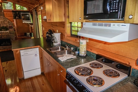Kitchen with white appliances at Seclusion, a 1 bedroom cabin rental located in Gatlinburg