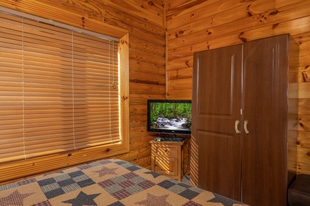 TV and armoire in a bedroom at Gone Fishin', a 2-bedroom cabin rental located in Pigeon Forge