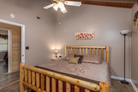 Bedroom with log bed, night stand, and lamps at Forever Country, a 3 bedroom cabin rental located in Pigeon Forge