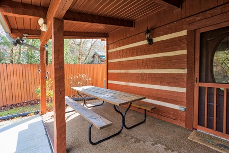 Picnic table on a patio at Rustic Ranch, a 2 bedroom cabin rental located in Pigeon Forge