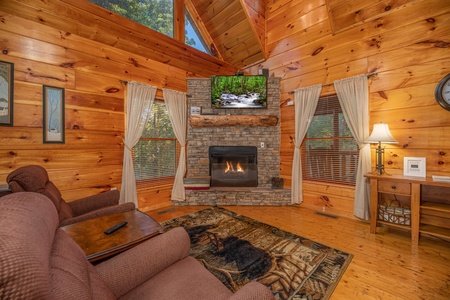 Living room with fireplace and TV at Firefly Ridge, a 2 bedroom cabin rental located in Pigeon Forge