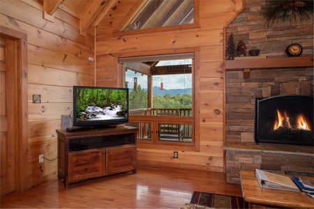 Living room with a television, fireplace, and mountain views at Cedar Creeks, a 2-bedroom cabin rental located near Douglas Lake