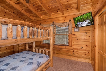 Bunk room with a television at Mountain View Meadows, a 3 bedroom cabin rental located in Pigeon Forge