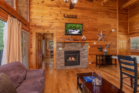 Living room with fireplace and TV at Majestic Sunrise, a 1 bedroom cabin rental located in Pigeon Forge