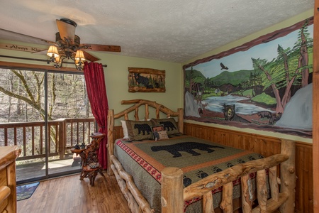Bedroom space and deck access at Bear Mountain Hollow, a 1 bedroom cabin rental located in Pigeon Forge