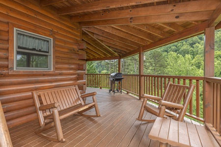Rocking chairs and rocking bench on a covered deck at Almost Bearadise, a 4 bedroom cabin rental located in Pigeon Forge
