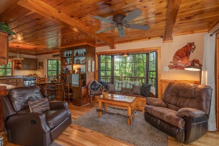 Chairs, sofa, and coffee table in the living roomat Hidden Pleasure, a 1-bedroom cabin rental located in Gatlinburg