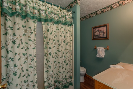 Bathroom with a tub and shower at Hideaway, a 1 bedroom cabin rental located in Pigeon Forge