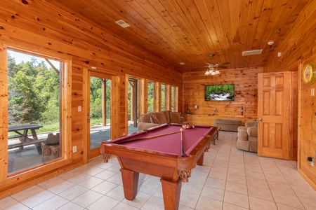 Red felted pool table in a game room at Cabin Fever, a 4-bedroom cabin rental located in Pigeon Forge