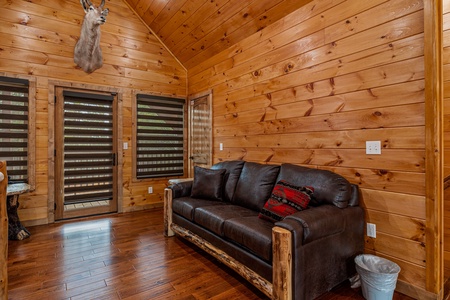 Leather couch in game room at Four Seasons Grand, a 5 bedroom cabin rental located in Pigeon Forge