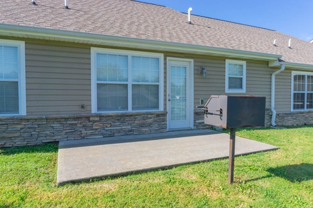 Back patio and charcoal grill at A Pigeon Forge Retreat, a 2 bedroom cabin rental located in Pigeon Forge